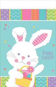 white Easter table cover with a border that has a bunny and pastel colours 