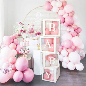 Fillable balloon boxes. Picture shows a party set up in a pink and white theme with the word "baby" spelled out on the balloon boxes