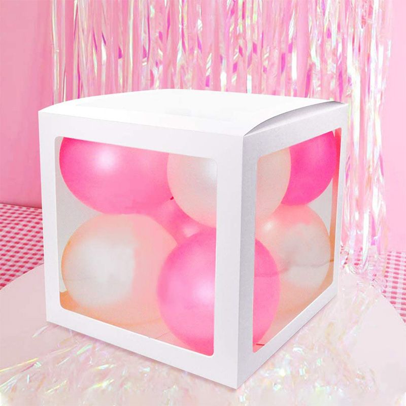Fillable cardboard balloon box with pink and peach balloons inside 